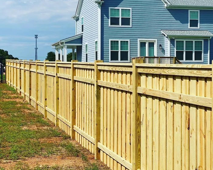 Pressure treated privacy fence running the length of a new build in Mooresville